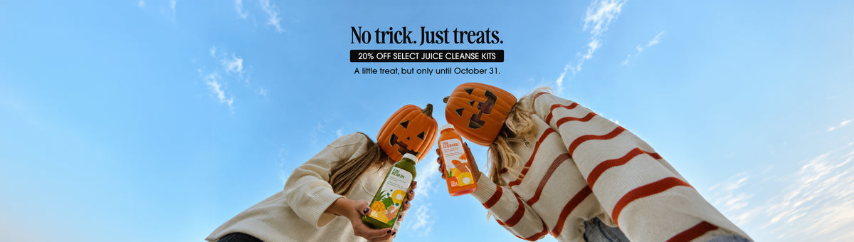 Two people holding juice truck juices, dressed in Jack-o-Lantern heads for Halloween. Save 20% Off Select Juice Cleanse until October 31