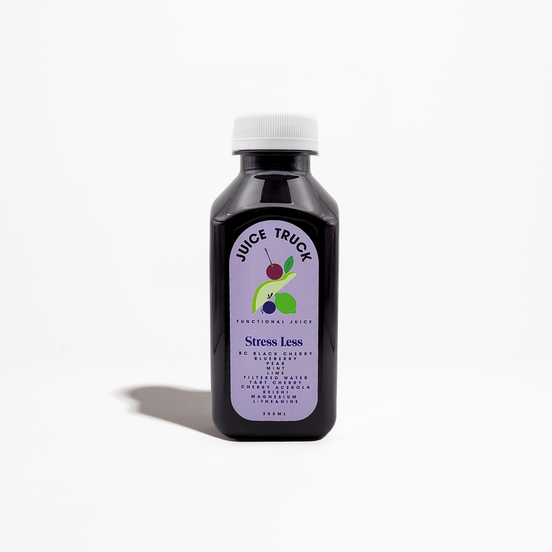 A bottle of 'Juice Truck' branded juice with a label that reads 'Stress Less' and lists the ingredients such as black cherry, blueberry, pear, mint, lime, reishi mushroom, magnesium, and L-theanine.