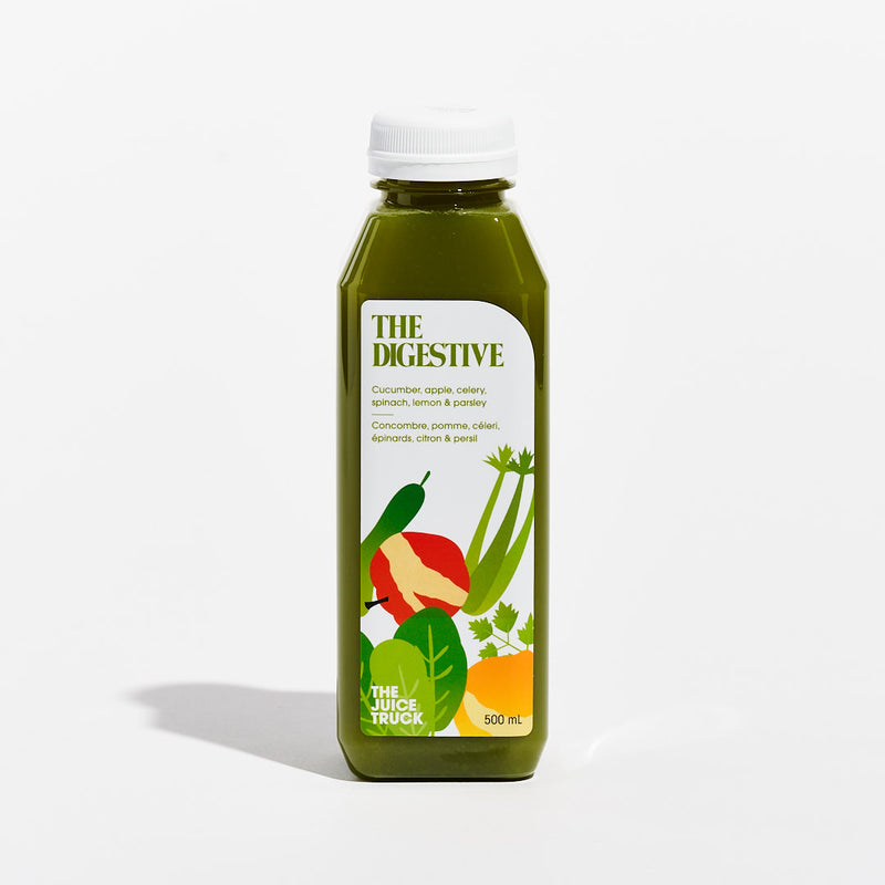 A bottle labeled 'THE DIGESTIVE' with illustrations of vegetables such as cucumber, apple, celery, spinach, lemon, and parsley.