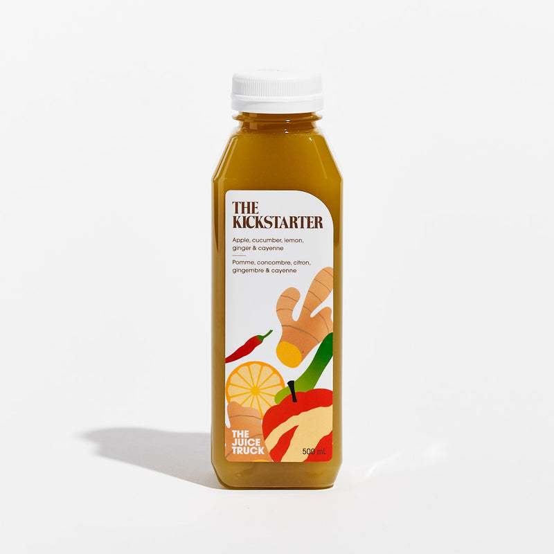 A bottle of juice labeled 'THE KICKSTARTER' with illustrations of an apple, lemon, and ginger on the label, indicating it is a fruit juice blend.