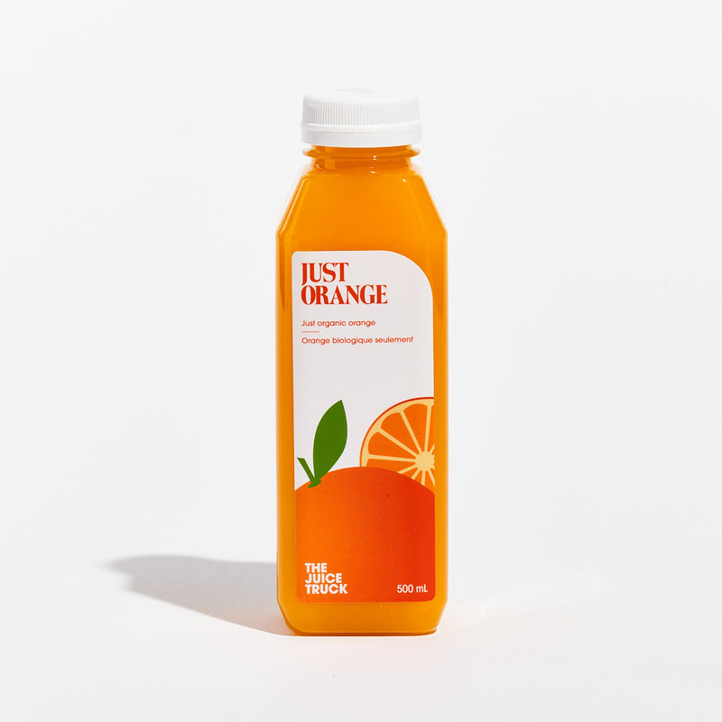 A bottle of Just organic cold-pressed orange juice, with a predominantly orange label and a depiction of an orange slice.