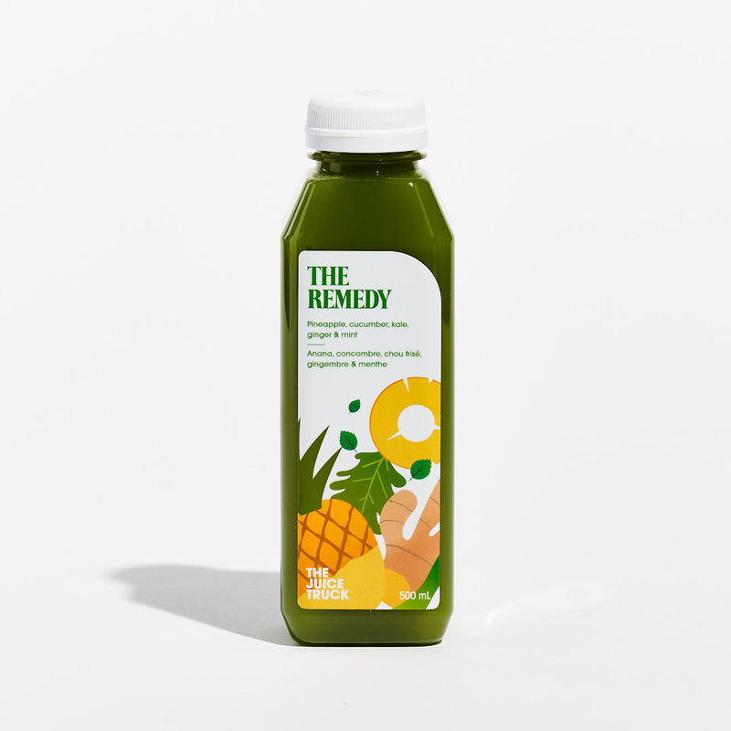 A bottle of juice labeled 'THE REMEDY' with illustrations of pineapple, kale, and other ingredients on the label.