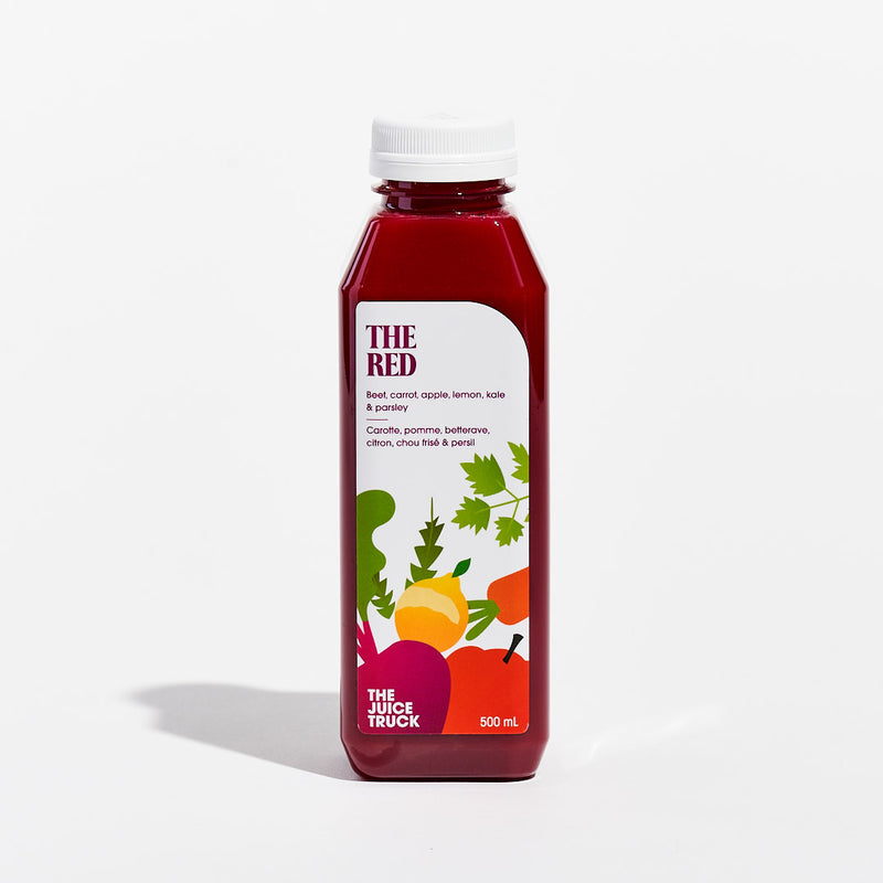A bottle of juice labeled 'THE RED' with images of carrot, apple, beet, lemon, kale, and parsley.